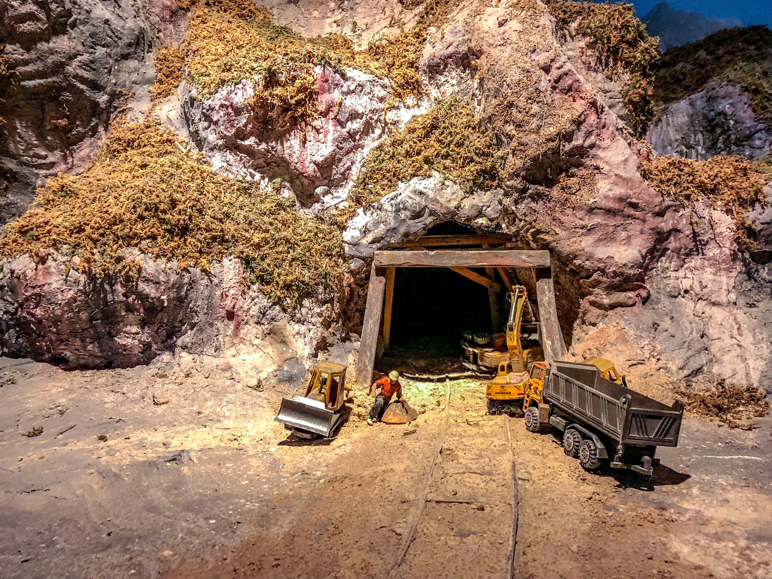mini models miner front of the cave for mining.